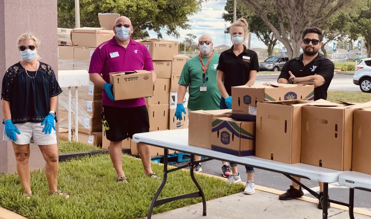 The YMCA of the Suncoast's West Pasco branch, located at 8411 Photonics Dr. in Trinity, works with Feeding Tampa Bay to hand out food to needy families on April 6, 2020.