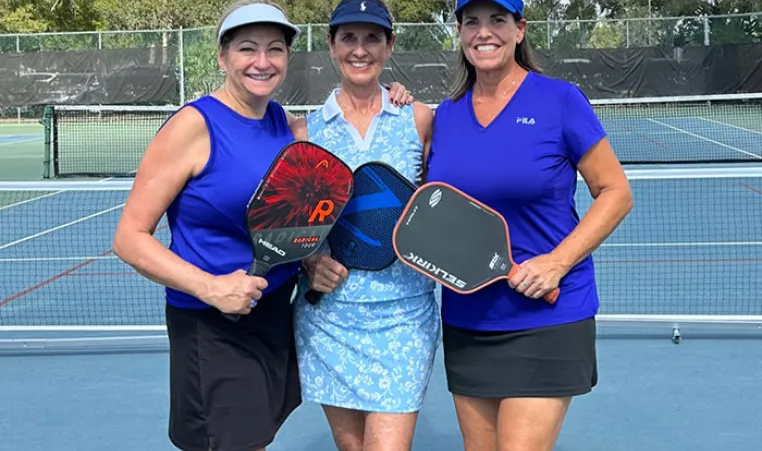Kat Orr, Kelly Westbrook and Robbie McKee pose for a photo at the John Geigle YMCA pickleball courts.