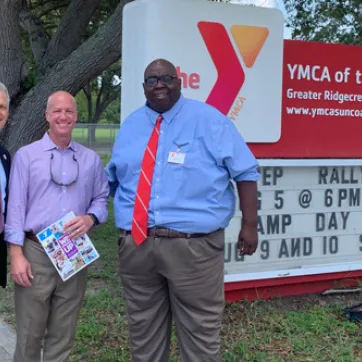 YMCA of the Suncoast CEO, State Representative Nick DiCeglie and Director Brad Barnes outside the YMCA of the Ridgecrest red marquee